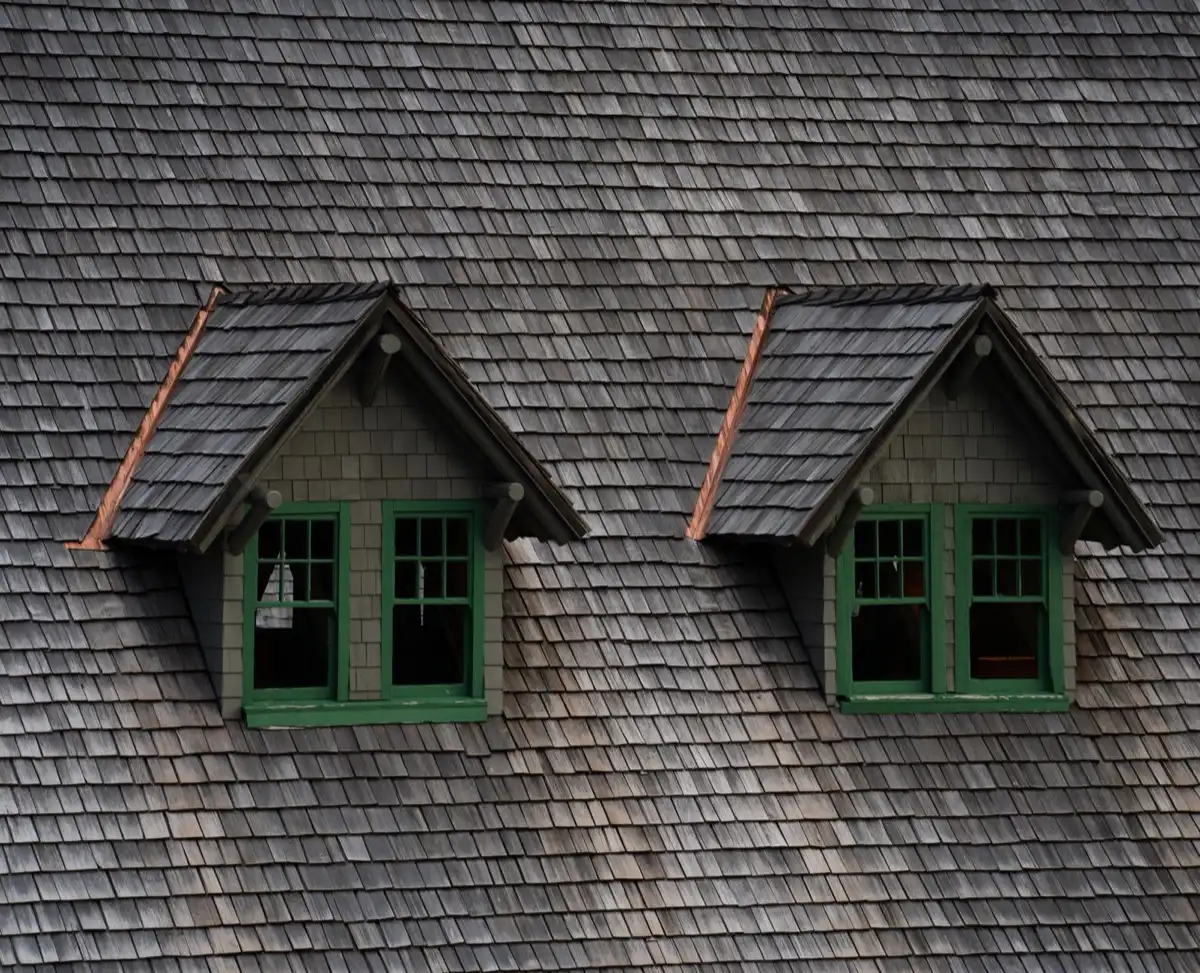 Dormers on a shingle roof in Victoria, TX, where step flashing and kickout flashing carry water past the walls
